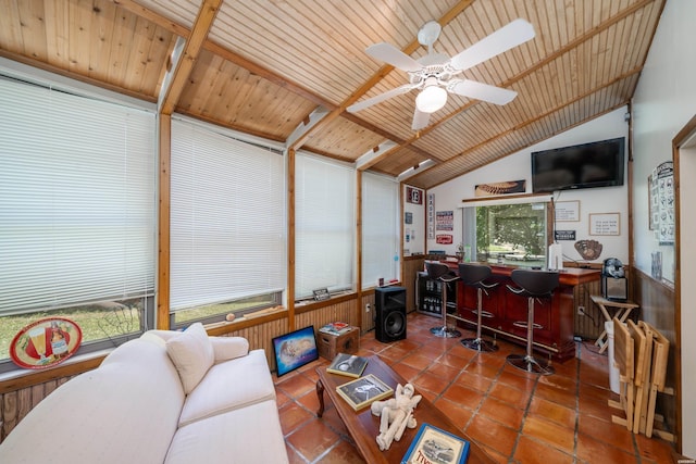 living area with a dry bar, wooden ceiling, vaulted ceiling, and tile patterned floors