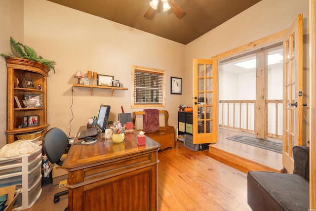 office area with light wood-style floors, a ceiling fan, and french doors