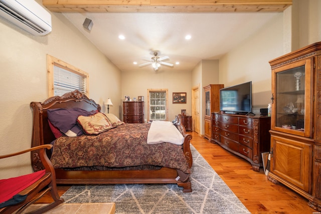 bedroom featuring a wall unit AC, recessed lighting, lofted ceiling with beams, a ceiling fan, and wood finished floors