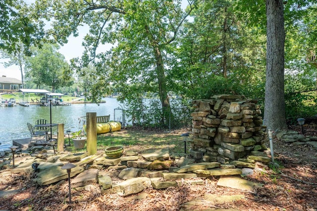 view of yard featuring a water view and a boat dock