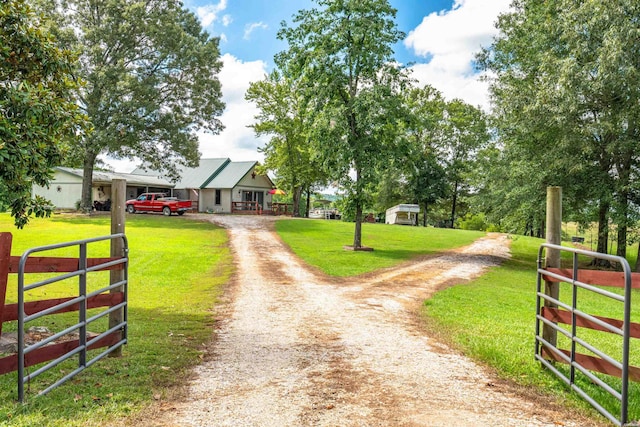 view of road featuring driveway and a gated entry