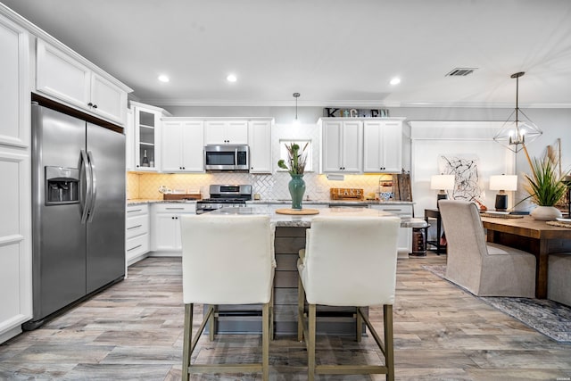 125 Eagle View Pt, Hot Springs, AR 71913 - kitchen featuring appliances with stainless steel finishes, crown molding, white cabinets, recessed lighting, and backsplash