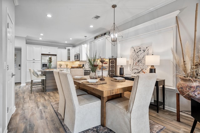 125 Eagle View Pt, Hot Springs, AR 71913 - dining room with crown molding, wood finished floors, recessed lighting, baseboards, and a chandelier