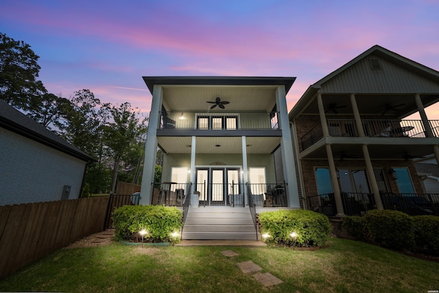 125 Eagle View Pt, Hot Springs, AR 71913 - back of property at dusk with ceiling fan, a balcony, french doors, and covered porch