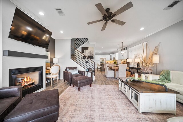 125 Eagle View Pt, Hot Springs, AR 71913 - living area with crown molding, light wood-style flooring, recessed lighting, ceiling fan, and stairway