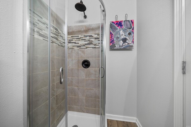 125 Eagle View Pt, Hot Springs, AR 71913 - bathroom with a shower stall, baseboards, and wood finished floors