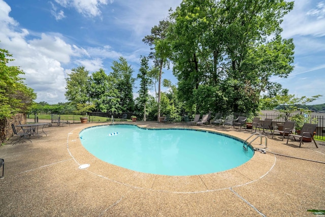 pool featuring a patio area and fence