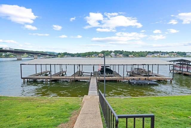 view of dock with a yard, a water view, and boat lift