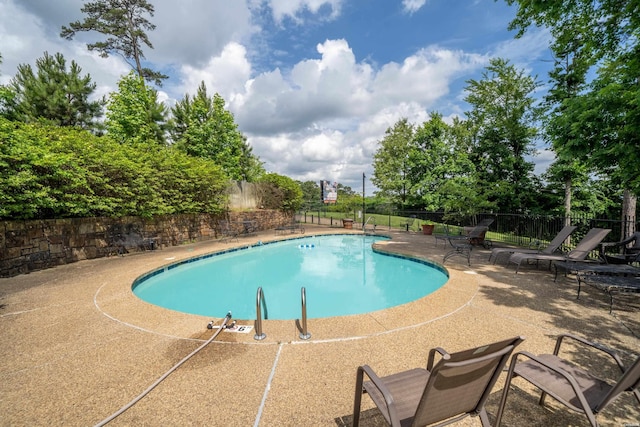 pool featuring a patio area and fence