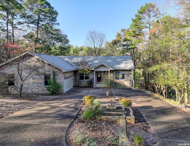 view of front facade with a garage and aphalt driveway