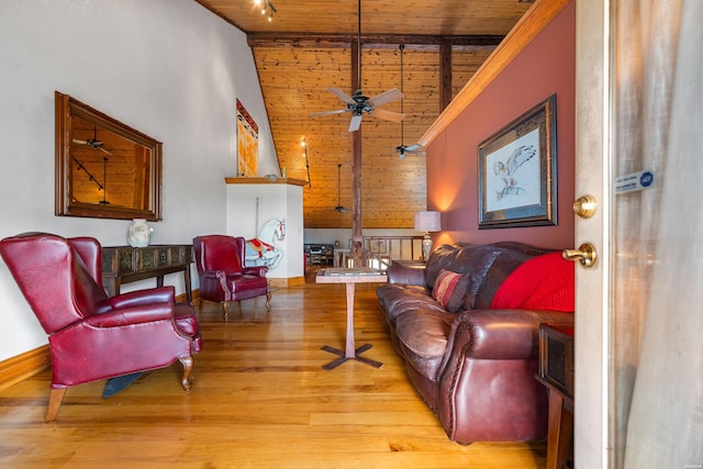 living area with baseboards, track lighting, wood ceiling, and light wood-style floors