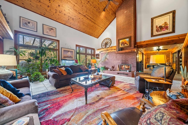 living room with a brick fireplace, wood ceiling, ceiling fan, high vaulted ceiling, and tile patterned flooring