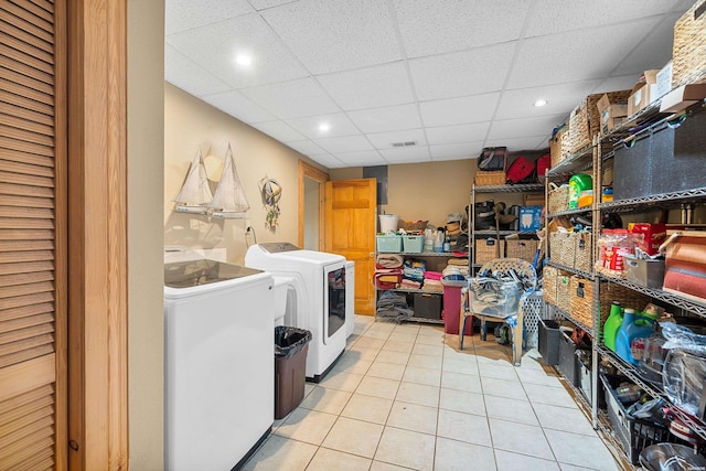 washroom with washing machine and dryer, laundry area, visible vents, and light tile patterned floors