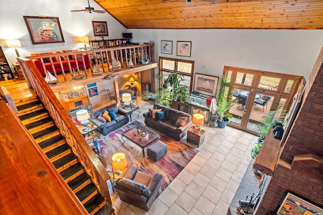 living area with stairs, high vaulted ceiling, wood ceiling, and a ceiling fan