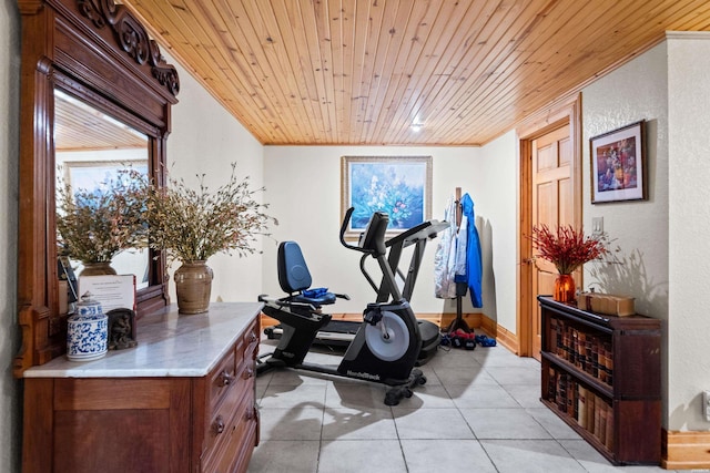 exercise area with ornamental molding, a wealth of natural light, wooden ceiling, and light tile patterned floors