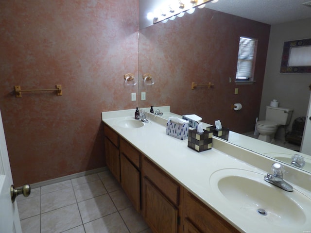 bathroom with toilet, tile patterned flooring, and a sink