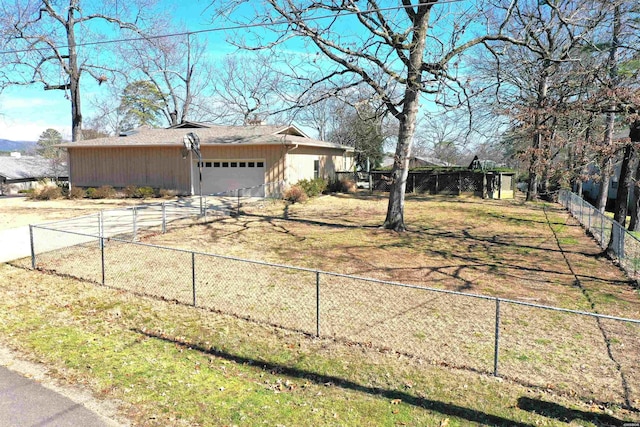 exterior space featuring driveway, an attached garage, and fence