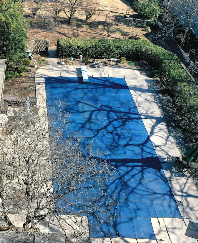 view of swimming pool featuring a patio and fence