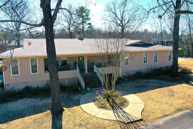 view of front of house with crawl space, stairs, and roof with shingles