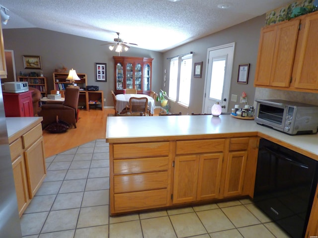 kitchen featuring light countertops, open floor plan, a textured ceiling, dishwasher, and a peninsula