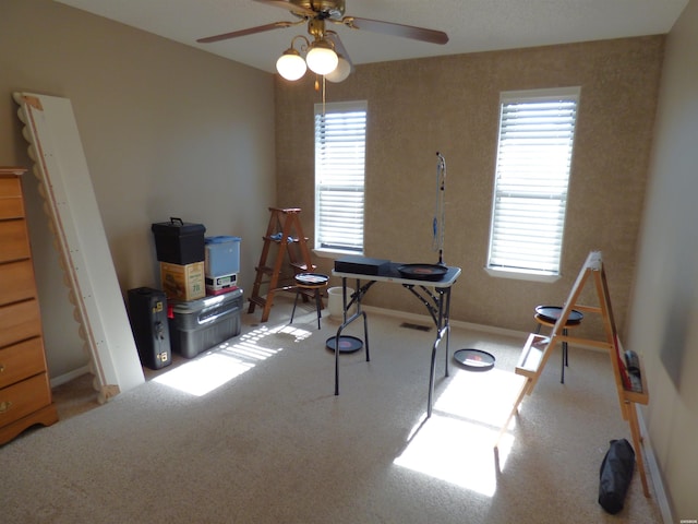 miscellaneous room featuring a ceiling fan and baseboards