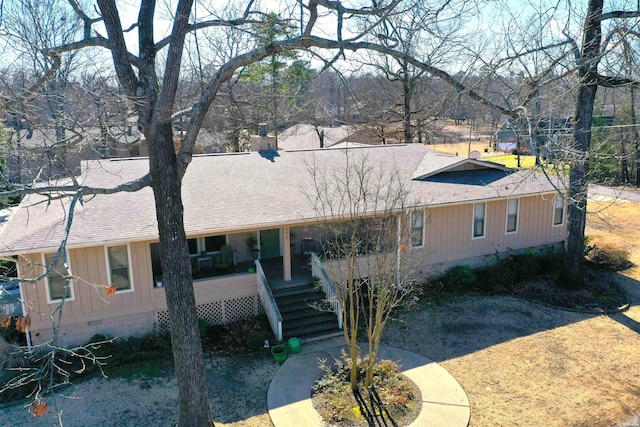 view of front of house featuring stairs, crawl space, roof with shingles, and a chimney