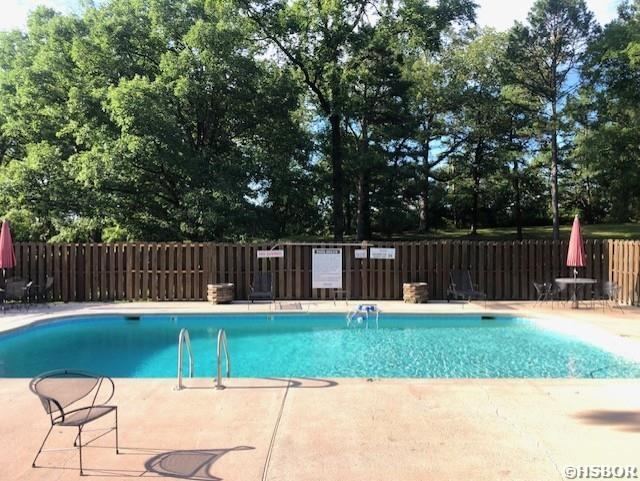 pool featuring a patio and fence