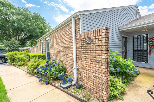 view of property exterior featuring brick siding