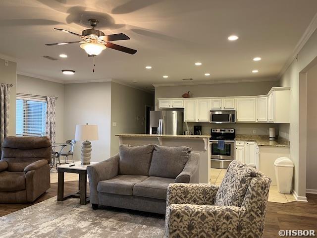 107 Legacy Ln, Hot Springs, AR 71901 - living room featuring ceiling fan, recessed lighting, wood finished floors, baseboards, and crown molding