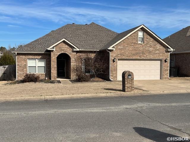 107 Legacy Ln, Hot Springs, AR 71901 - view of front of home with a garage, driveway, a shingled roof, and brick siding