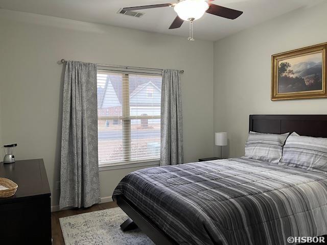 107 Legacy Ln, Hot Springs, AR 71901 - bedroom featuring ceiling fan, baseboards, visible vents, and dark wood finished floors