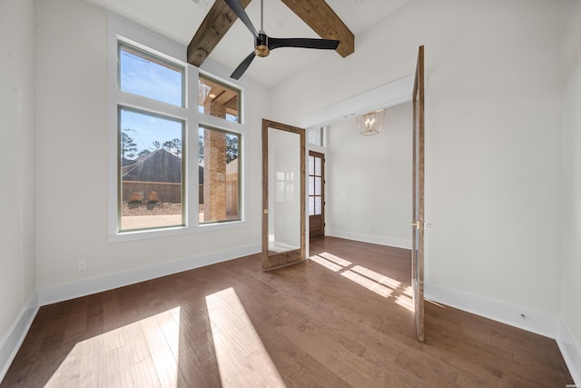 unfurnished room with baseboards, dark wood-type flooring, beamed ceiling, and ceiling fan with notable chandelier