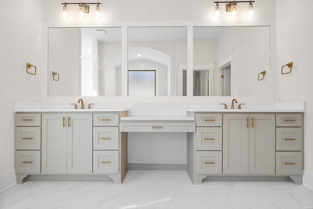 bathroom featuring marble finish floor, vanity, and baseboards