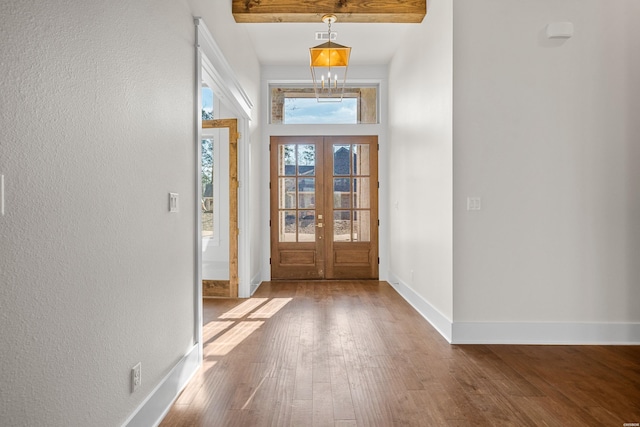 entryway featuring an inviting chandelier, baseboards, wood finished floors, and french doors