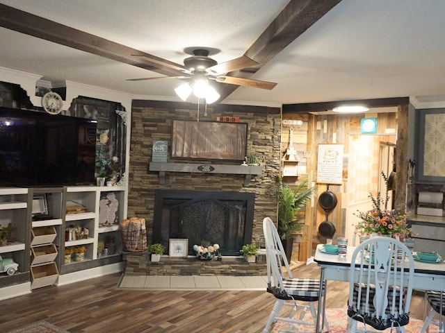 living room featuring ornamental molding, a textured ceiling, ceiling fan, and wood finished floors