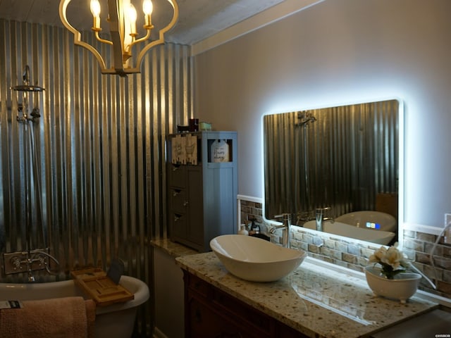 bathroom with a chandelier, tasteful backsplash, and vanity