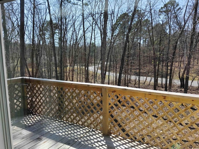 wooden deck with a forest view