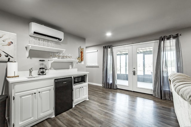 kitchen with french doors, light countertops, an AC wall unit, white cabinets, and fridge