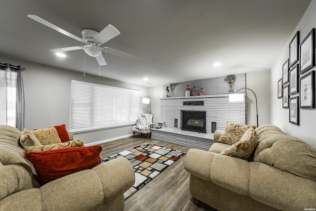 living area with ceiling fan, a fireplace, wood finished floors, and recessed lighting