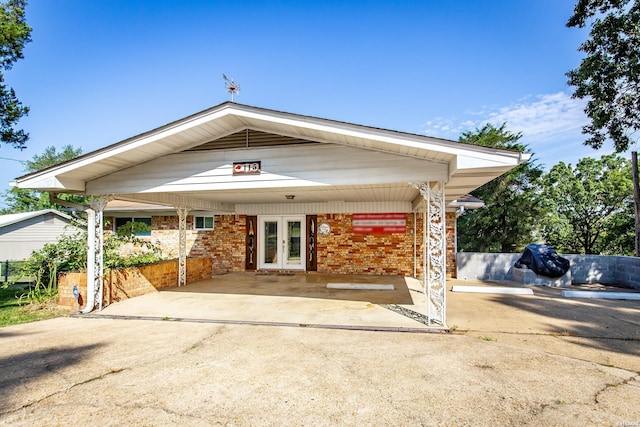 view of property featuring driveway and an attached carport