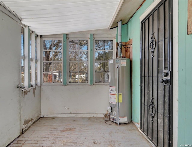 exterior space featuring lofted ceiling, water heater, and a wealth of natural light