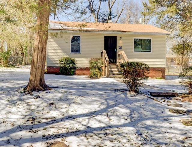 view of front of home featuring crawl space and fence