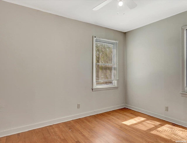 empty room with light wood-style flooring, baseboards, and ceiling fan