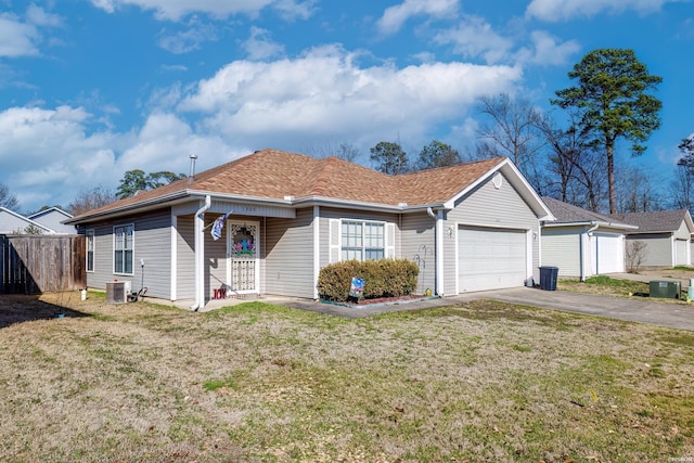 ranch-style home featuring an attached garage, central AC unit, a front yard, fence, and driveway