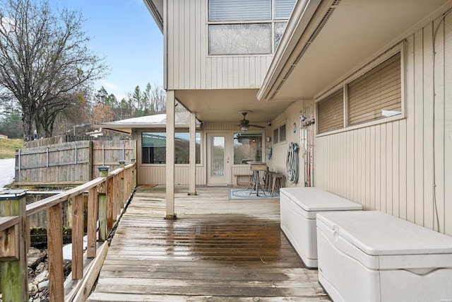 wooden terrace featuring ceiling fan and fence