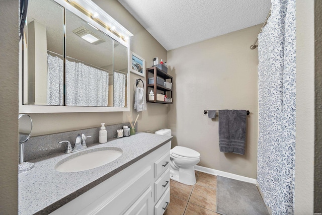 bathroom with baseboards, toilet, tile patterned flooring, a textured ceiling, and vanity