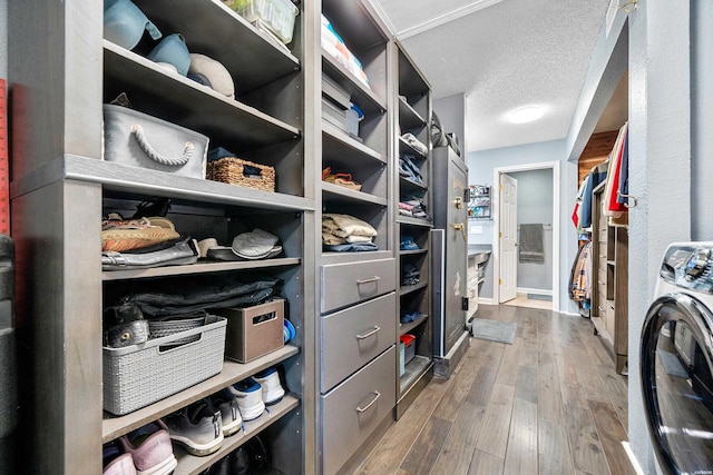 spacious closet with washer / clothes dryer and wood finished floors