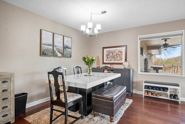 dining room with dark wood-style floors, a textured ceiling, baseboards, and an inviting chandelier