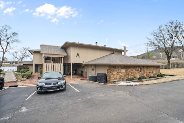 exterior space with uncovered parking and fence