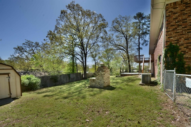 view of yard featuring a shed, cooling unit, and a fenced backyard